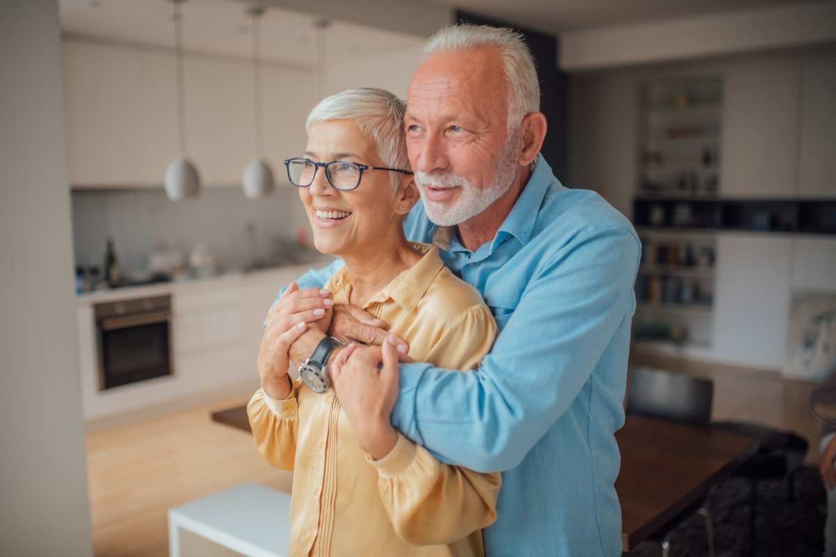 photo of an older couple looking at the window of their Iowa aging in place home.